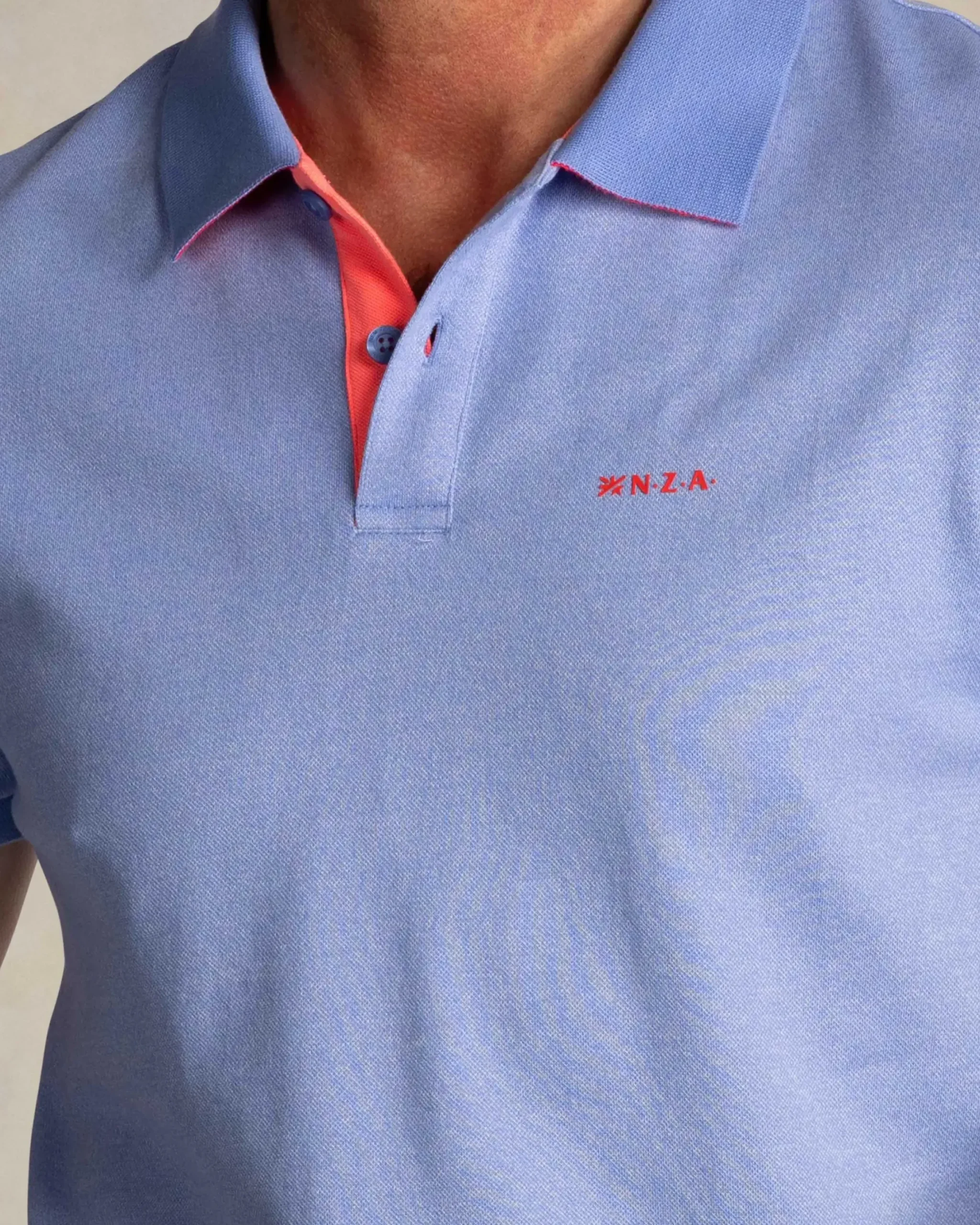 Effen lichtblauwe polo met oranje details